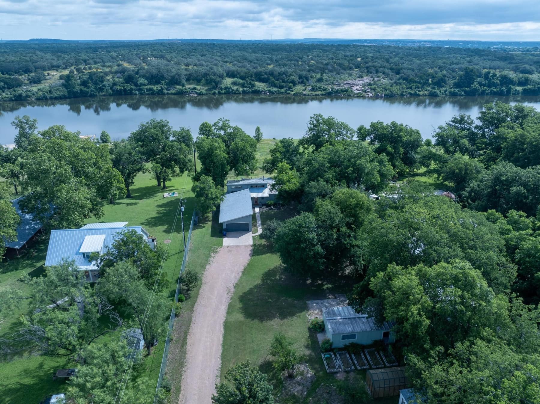 Aerial view of the house, outbuildings, and Lake Marble Falls