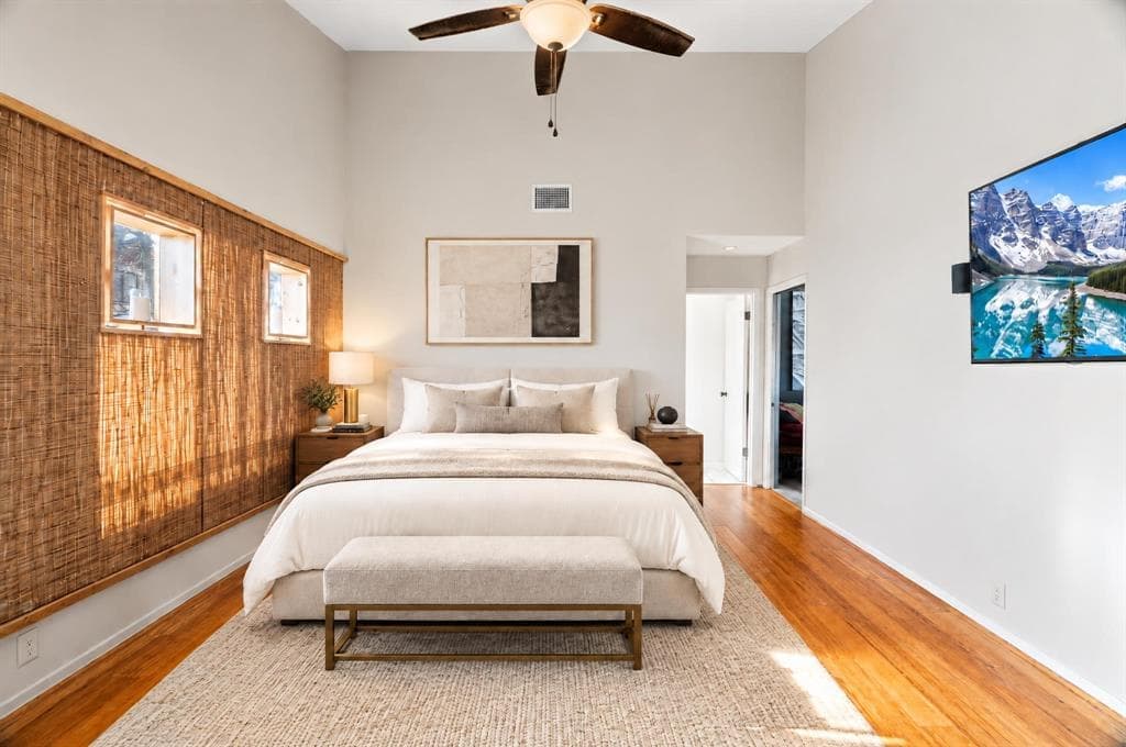 Bedroom with a woven wood wall and warm afternoon light