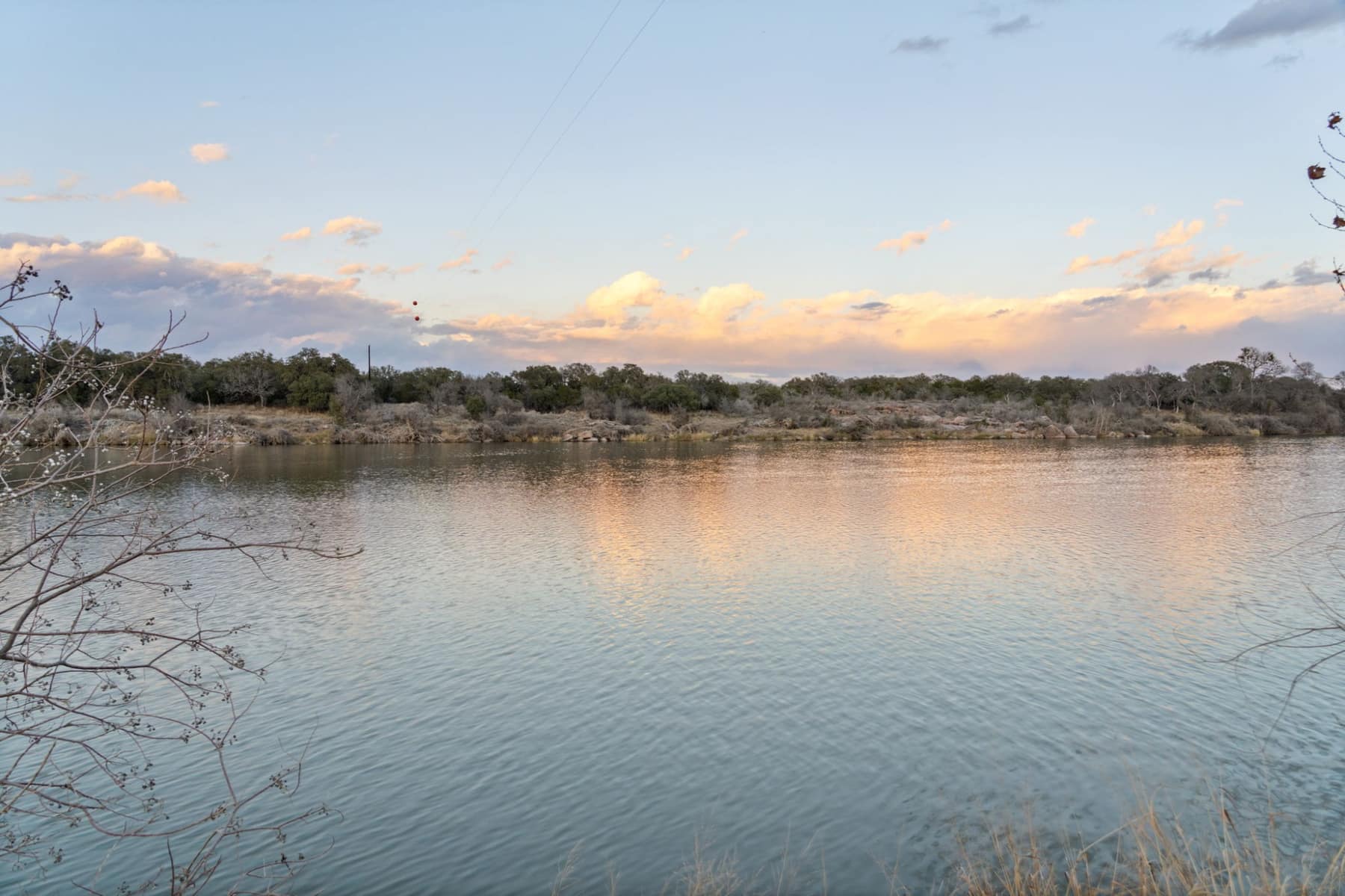 Calm lake water reflecting the evening sky