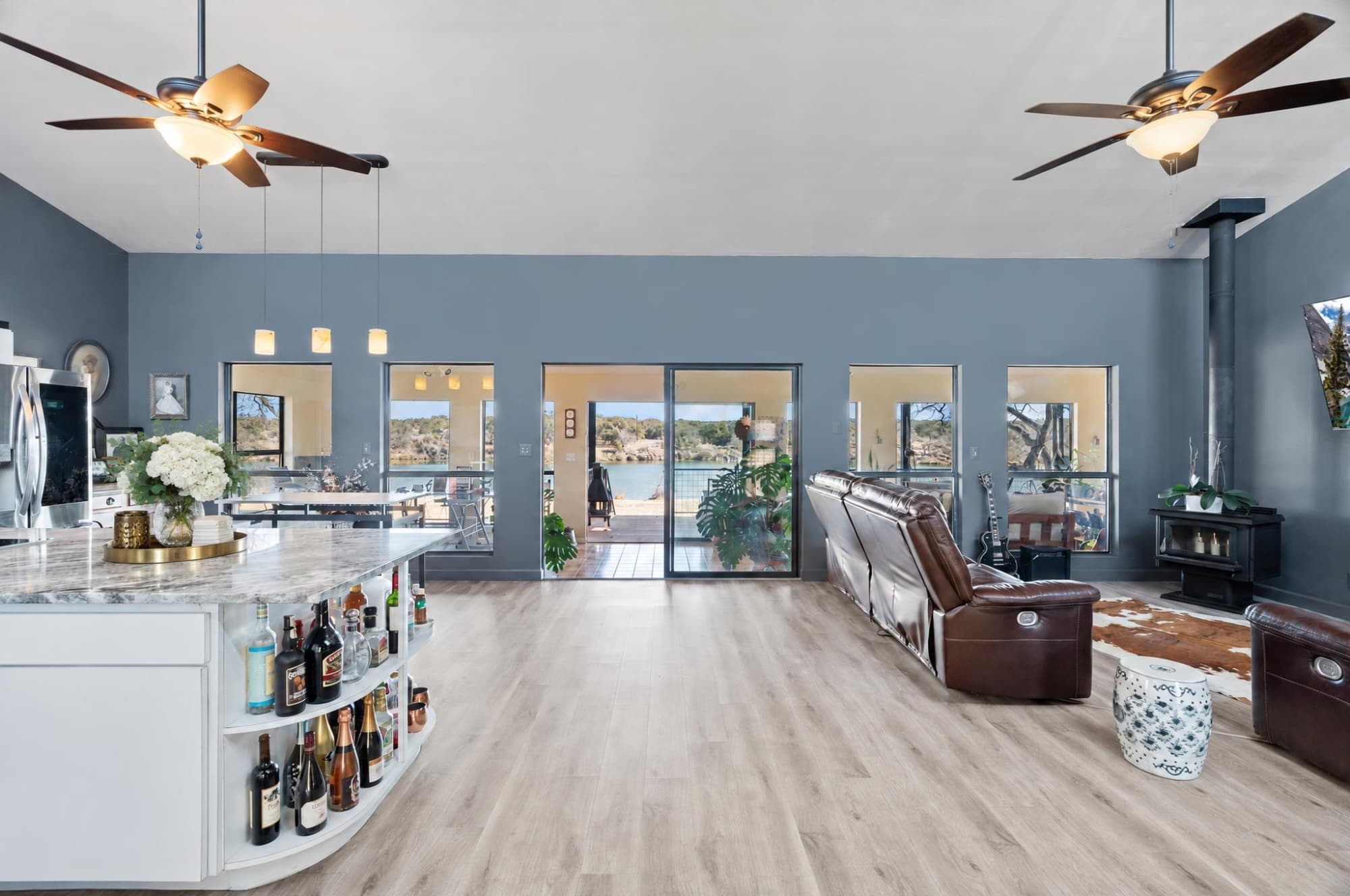 Open living room looking through glass doors to Lake Marble Falls